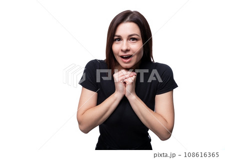 Caucasian young attractive brunette woman wearing a black t-shirt on a white background Caucasian young attractive brunette woman wearing a black t-shirt on a white background 108616365