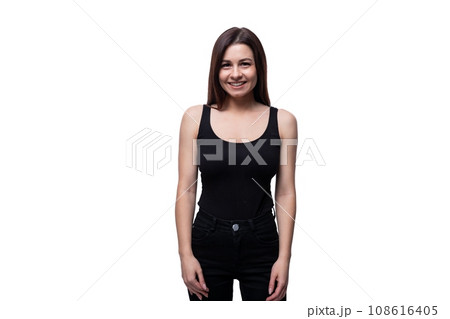 A 25-year-old woman with black hair stands confidently and holds her arms along her body 108616405