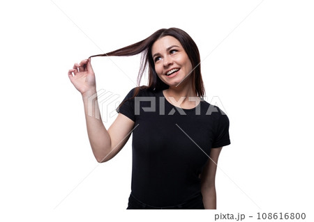 Young slender brunette woman with straight short hair wearing a black T-shirt 108616800