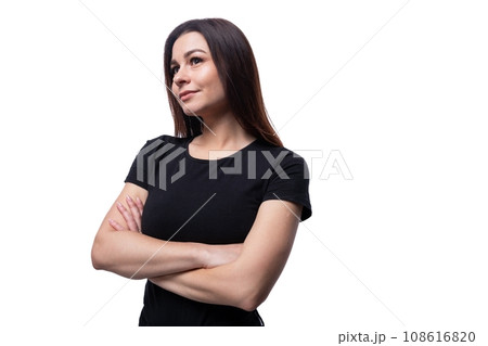 Confident beautiful young brunette woman in black t-shirt on white clean background Confident beautiful young brunette woman in black t-shirt on white clean background 108616820