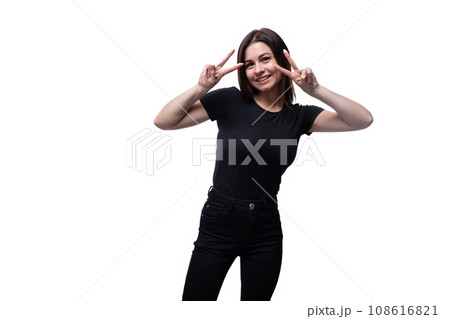 25 year old brunette woman with brown eyes greets and smiles against a background with copy space 25 year old brunette woman with brown eyes greets and smiles against a background with copy space 108616821