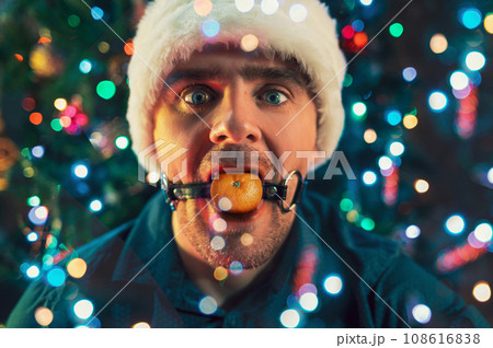 Happy man calling friends for Christmas using his phone Happy man calling friends for Christmas using his phone 108616838