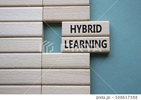 Hybrid learning symbol. Concept word Hybrid learning on wooden blocks. Beautiful grey green background. Business and Hybrid learning concept. Copy space Hybrid learning symbol. Concept word Hybrid learning on wooden blocks. Beautiful grey green background. Business and Hybrid learning concept. Copy space 108617388