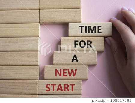 Time for a new start symbol. Wooden blocks with words Time for a new start. Beautiful pink background. Businessman hand. Business and Time for a new start concept. Copy space. 108617393
