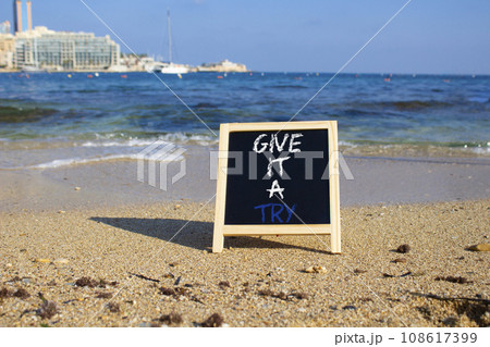 Give it a try symbol. Concept words Give it a try on chalk blackboard. Beautiful sea background. Business and Give it a try concept. Copy space. 108617399
