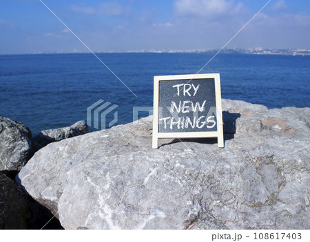 Try new Things symbol. Concept words Try new Things on black chalk blackboard blocks. Beautiful sea green background. Business and Try new Things concept. Copy space. Try new Things symbol. Concept words Try new Things on black chalk blackboard blocks. Beautiful sea green background. Business and Try new Things concept. Copy space. 108617403
