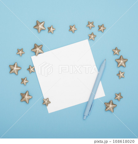 Blank greeting card for your text with pen and decorative stars on cyan background Blank greeting card for your text with pen and decorative stars on cyan background 108618020