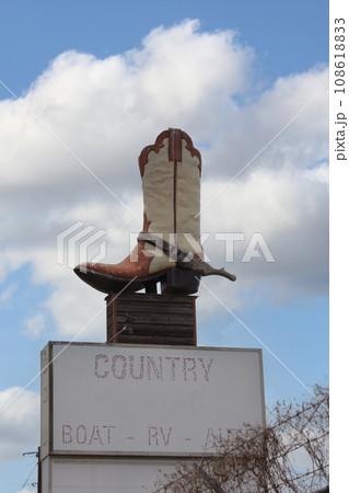 Giant Cowboy Boot on Sign of Abandoned Business Located in Rural Texas. Weir TX Giant Cowboy Boot on Sign of Abandoned Business Located in Rural Texas. Weir TX 108618833