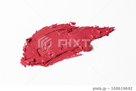 A sample of red lipstick is isolated on a white background. Texture of lipstick. A sample of red lipstick is isolated on a white background. Texture of lipstick. 108619692