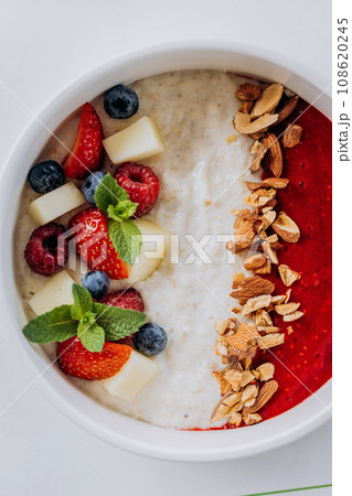 Sweet milk semolina porridge with strawberries on beautiful plate. Delicious breakfast for children 108620245