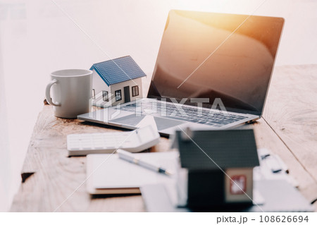 Real estate broker agent presenting and consult to customer to decision making sign insurance form agreement, buy and sell home model, concerning mortgage loan offer for and house insurance Real estate broker agent presenting and consult to customer to decision making sign insurance form agreement, buy and sell home model, concerning mortgage loan offer for and house insurance 108626694