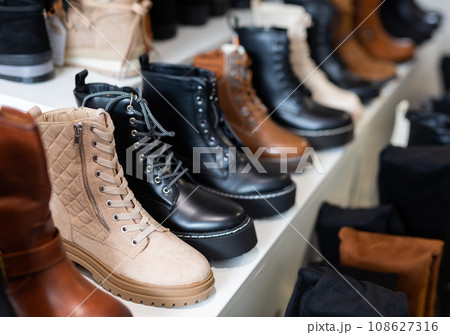 Shelves with boots in shoe store 108627316