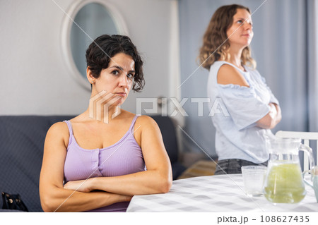 Offended girlfriends ignoring each other after quarrel 108627435