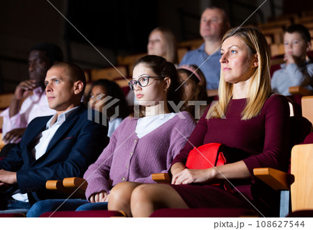 Family viewing of spectacle or concert in theater auditorium Family viewing of spectacle or concert in theater auditorium 108627544
