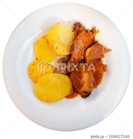 Braised pork in tomato sauce, served with bread and wine, closeup 108627580