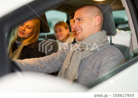 Family having fun and smiling while driving in the car 108627605