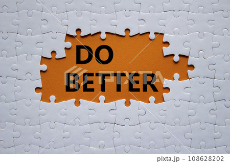 Do better symbol. White puzzle with words Do better. Beautiful orange background. Business and Do better concept. Copy space. 108628202