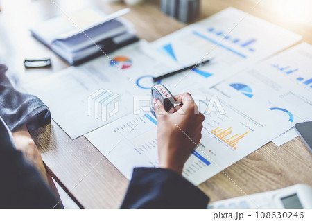 Picture of African Americans businesswoman stamping budget approval on financial documents 108630246