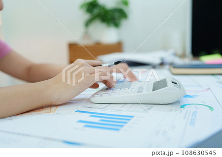 Accountants, Asian auditors are using calculators and computers to review annual tax budgets to submit information to the IRS Accountants, Asian auditors are using calculators and computers to review annual tax budgets to submit information to the IRS 108630545