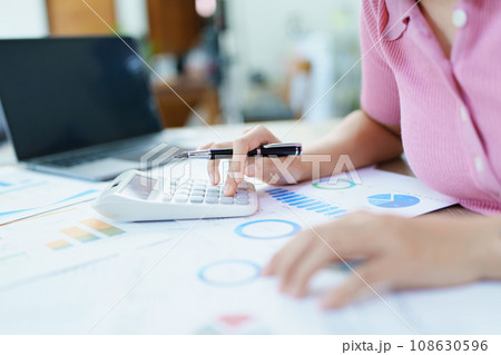 Accountants, Asian auditors are using calculators and computers to review annual tax budgets to submit information to the IRS 108630596