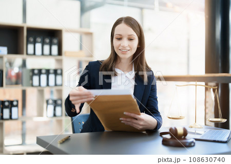 Portrait of a Asian woman lawyer studying a lawsuit for a client before going to court. 108630740