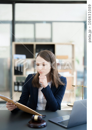 Portrait of a Asian woman lawyer studying a lawsuit for a client before going to court. Portrait of a Asian woman lawyer studying a lawsuit for a client before going to court. 108631089