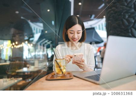 Business freelance asian woman using smartphone and laptop computer at cafe restaurant lifestyle Business freelance asian woman using smartphone and laptop computer at cafe restaurant lifestyle 108631368