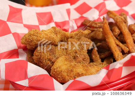 Fried Catfish Basket With French Fries in Rustic Cafe Fried Catfish Basket With French Fries in Rustic Cafe 108636349