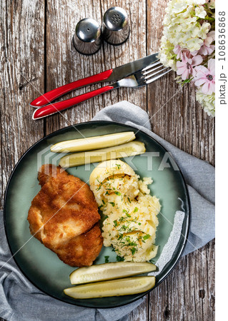 Pork chop served with mashed potatoes and pickled cucumber. Pork chop served with mashed potatoes and pickled cucumber. 108636868