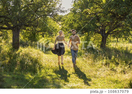 young couple walking in nature young couple walking in nature 108637079