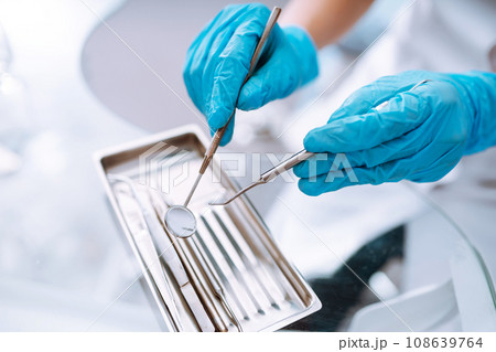 A set of sterile dental instruments for dental treatment. Dental care for people. 108639764