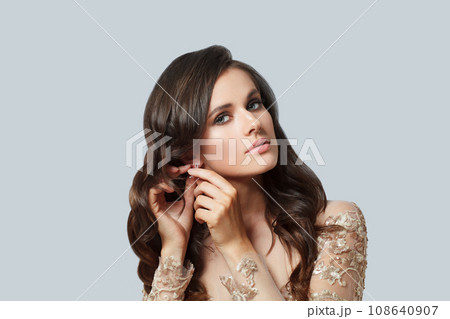 Lovely brunette woman with makeup, healthy hair and luxurious jewelry earring Lovely brunette woman with makeup, healthy hair and luxurious jewelry earring 108640907