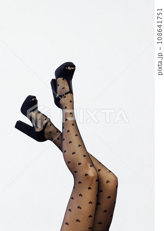 Beautiful slender female legs in black pantyhose stockings Beautiful slender female legs in black pantyhose stockings 108641751