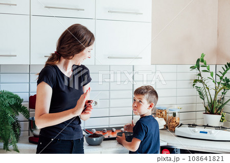 Woman housewife with son cooking food dinner in kitchen 108641821