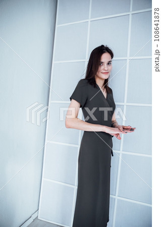 Woman in dress posing in bright room Woman in dress posing in bright room 108641878