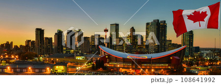 Canadian flag in Calgary city skyline at twilight time, Alberta,Canada 108641992