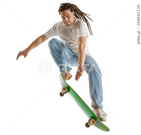 Talented young man, skateboarder dressed modern fashion outfit and haircut performing tricks in motion isolated white background. Talented young man, skateboarder dressed modern fashion outfit and haircut performing tricks in motion isolated white background. 108642130