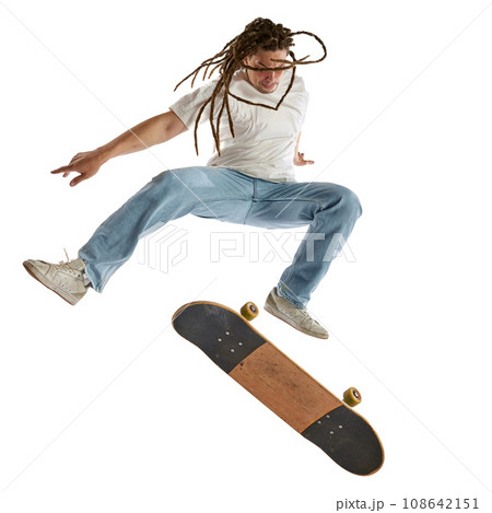 Dynamic portrait of young athletic man with dreadlocks training with skateboard isolated white studio background. Concept of activity. Dynamic portrait of young athletic man with dreadlocks training with skateboard isolated white studio background. Concept of activity. 108642151