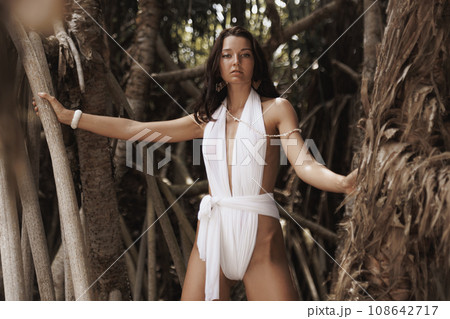 Luxury Fashion Shot in the Wild of Beach Woman Model in Modern Swimsuit Luxury Fashion Shot in the Wild of Beach Woman Model in Modern Swimsuit 108642717