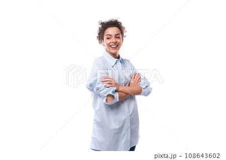 young smiling fashionista caucasian woman with curly black hair in glasses is dressed in a blue young smiling fashionista caucasian woman with curly black hair in glasses is dressed in a blue 108643602
