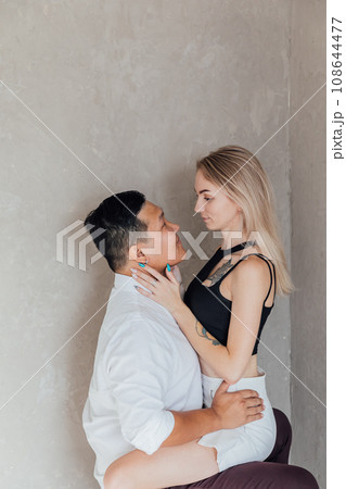 A couple of lovers, a man and a woman, sitting together in a room 108644477