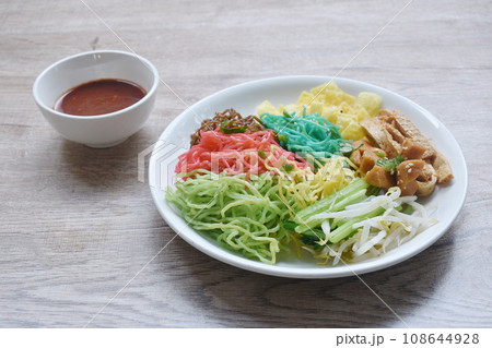 colorful noodles with sausage and fish line couple bean sprout on plate dressing spicy Korean sauce  108644928
