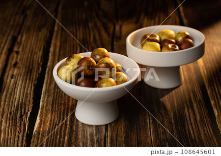 Sunlight shining on green dates on a wooden table board. Sunlight shining on green dates on a wooden table board. 108645601
