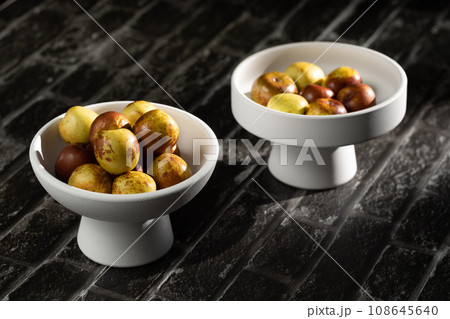 Sunlight shining on green dates on a slate board. 108645640