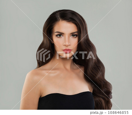 Gorgeous woman brunette with long healthy shiny dark brown wavy hair, clean skin and makeup  108646855