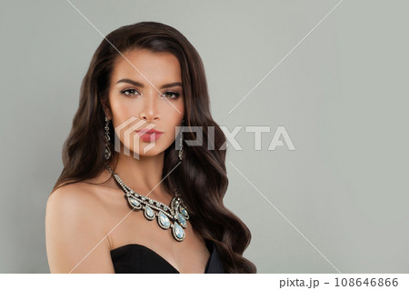 Perfect young fashion model woman brunette with long shiny curly hair, diamond jewelry earring  108646866