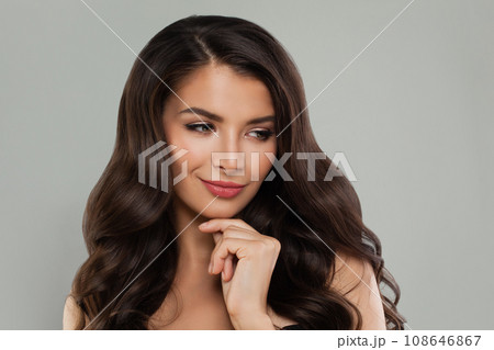 Fashion portrait of cheerful female model brunette with long curly hairstyle smiling. Fashion portrait of cheerful female model brunette with long curly hairstyle smiling. 108646867