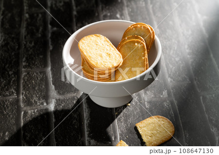 Sunlight shining on cookies on a slate board. Sunlight shining on cookies on a slate board. 108647130