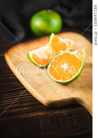 Oranges placed on a wooden board 108647180