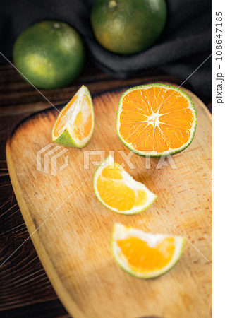 Oranges placed on a wooden board 108647185